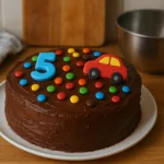 Photo d’un gâteau d’anniversaire pour garçon fait maison, moelleux et décoré simplement dans une cuisine familiale, idéal pour une fête d’enfant.